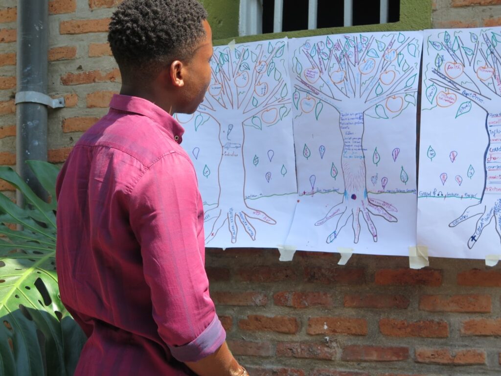 a young man looking at pictures of hand-drawn trees