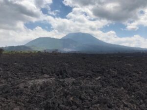 volcano in the distance with lava at the fore
